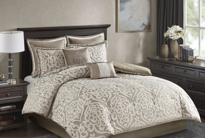 Add a touch of class to your bedroom with the Madison Park Odette 8 Piece Jacquard Comforter Set. The luxurious textured jacquard comforter and shams flaunt a gorgeous damask medallion design with ivory striations on the satin ground that add dimension to the lavish look. A solid neutral reverse and stunning Euro shams complement the top of the bed to complete the ensemble. Also included are two decorative pillows that feature embroidery and cording details