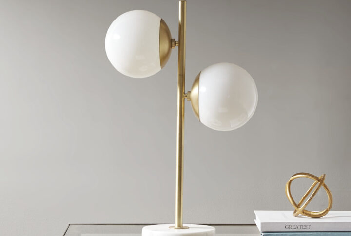 Update your space with the unique style of the INK+IVY Holloway Marble Base Table Lamp. This table lamp features a white glass shade and a metal fixture with a gold finish for a striking contrast. The rounded shape creates a truly modern look for your living room or bedroom. Two Type  A light bulbs are needed.