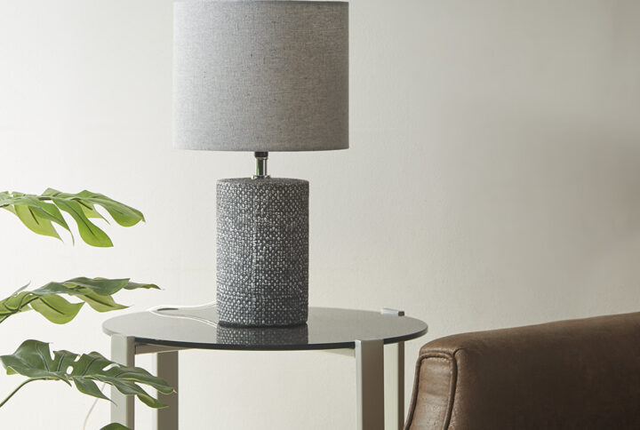 Complement your home decor with the bold modern style of 510 Design's Bayard Embossed Ceramic Table Lamp. The cylinder-shaped