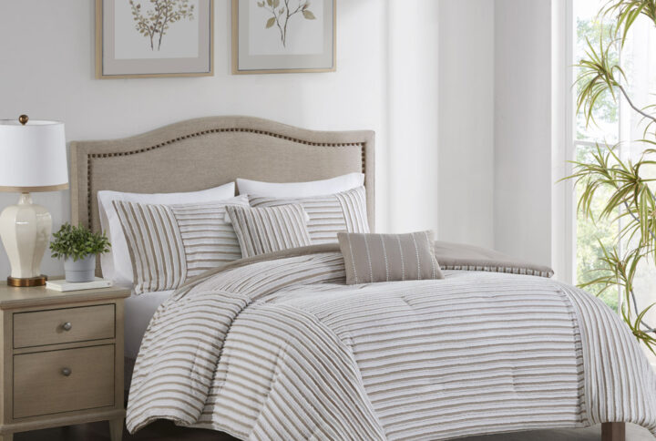 This casual farmhouse style comforter set features a pieced clip jacquard pattern in a white and natural two-tone stripe effect. Also included are two decorative pillows featuring either the matching clip jacquard design or embroidery details to add a touch of elegance to the overall design. Made with 100% hypoallergenic polyester filling