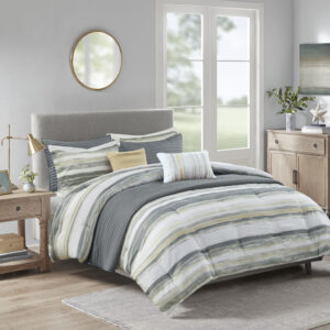 Create a relaxing and tranquil atmosphere in your bedroom with Madison Park’s Marina 8 Piece Printed Seersucker Comforter and Quilt Set Collection. The textured seersucker comforter features a watercolor stripe print in yellow and gray hues and a off white reverse