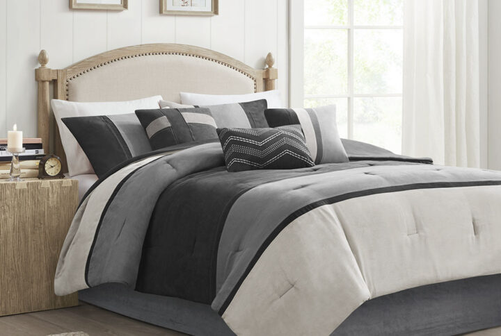 The Madison Park Palisades 7 Piece Faux Suede Comforter Set offers you a casual alternative in fashion bedding. The reverse of the comforter is solid black. The soft microsuede in light grey