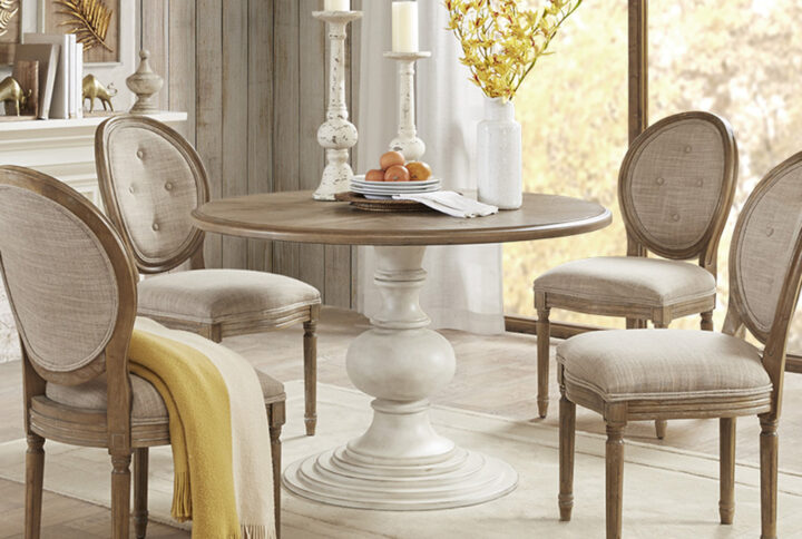 The Madison Park Lexi Dining Table provides a charming farmhouse allure for your dining room decor. This round dining table features a diamond veneer top in a reclaimed walnut wood finish. An antique cream finish on the pedestal base beautifully complements the table top