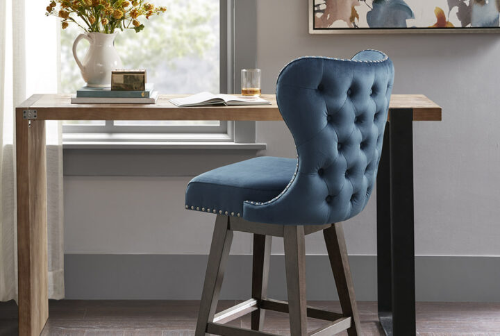 The Madison Park Hancock Swivel Counter Stool complements any kitchen with its simple and elegant design. This armless swivel counter stool flaunts a tufted wingback design with matte silver nail heads