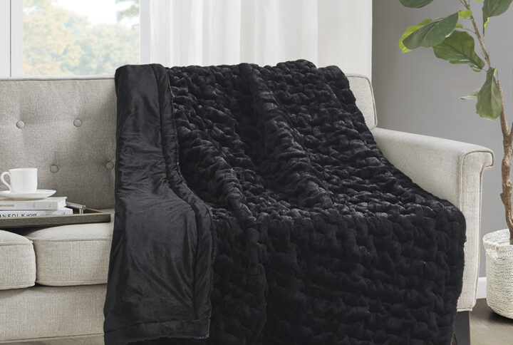 Add a modern and sophisticated touch to any space with the Madison Park Ruched Fur Throw. This throw features a solid ruched fur pattern