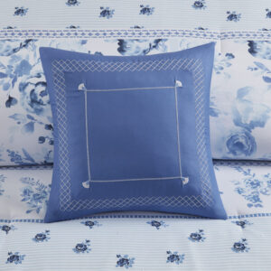 while 2 decorative pillows with embroidery and tassel details complete the charming