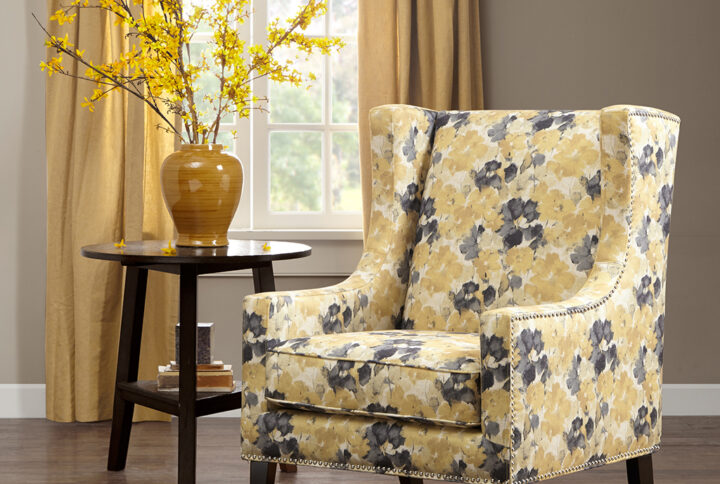 A wing back chair like this is a classic chair. Combining an updated print fabric with contrasting silver nail head