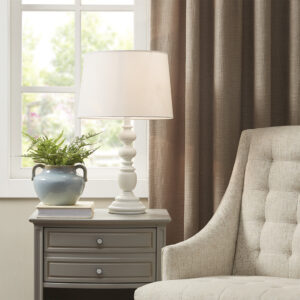 The Martha Stewart Astoria Resin Buffet Table Lamp offers a chic traditional update to your living room or bedroom. This table lamp features a resin frame in a matte white finish with a candle stick design to create a refined farmhouse look. The tapered lamp shade is made from linen to softly filter the light into your space and is not adjustable. This farmhouse table lamp also uses a rotary switch to find the right light setting and adds a subtle charm to your home decor. 1 Type-a light bulb is needed. Spot clean only. Comes with a 2-year warranty.