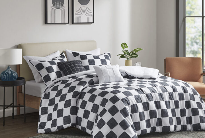 Transform your bedroom into a stylish space with this bold black and white checkered comforter set. The modern comforter and shams (1 in Twin/Twin XL) feature a textured checkered print that adds dimension and uniqueness