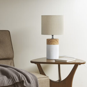 Elevate your decor and illuminate your home with the contemporary style of the 510 Design Nicolo Textured Ceramic Table Lamp. This round table lamp features a two-tone ceramic base in white with a brown wood grain pattern to create a stunning modern look. The drum lamp shade softly filters the light to provide a warm ambiance in your space. Flaunting a simple