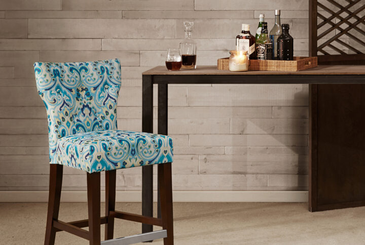 Change up your kitchen decor with the stunning style of the Madison Park Avila Tufted Back Counter Stool. This counter stool features a high button-tufted back upholstered in a multi-hued printed fabric