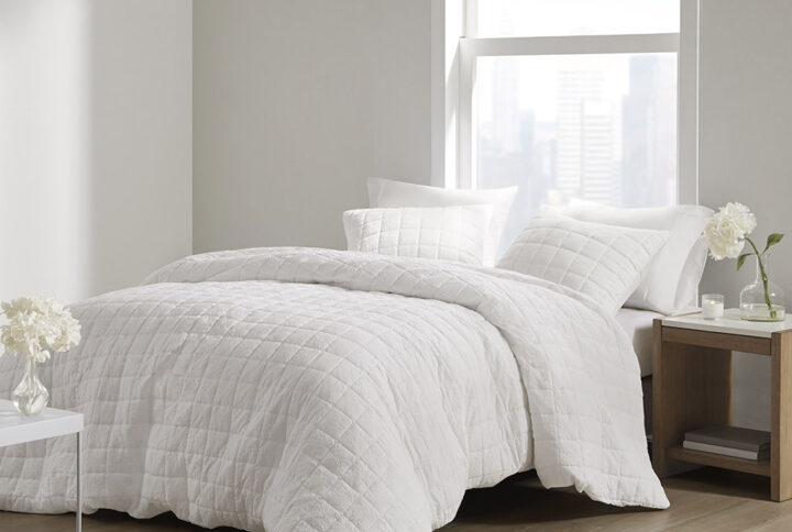 The simple elegance of the Cocoon 3 Piece Quilt Top Duvet Cover Mini Set by N Natori brings an elevated update to your bedroom. The oversized duvet cover flaunts super soft crushed microfiber with a lofty over-quilted box pattern