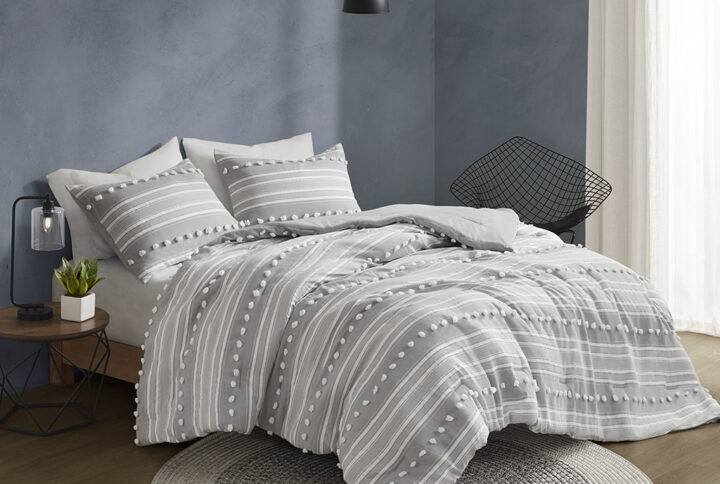 The Urban Habitat Rowan duvet cover set features cationic dyed stripes and clip jacquard pompom details that bring a perfect blend of modern and casual style to your bedroom. The duvet cover has a soft microfiber reverse