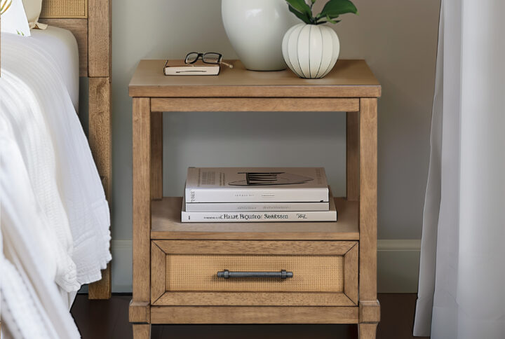 Discover the charm of Martha Stewart's Lily Pond Collection with the Salina Nightstand. This elegant piece features cane paneling and a pewter finish metal handle