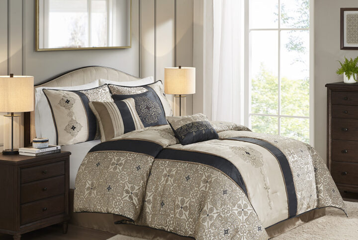 This traditional jacquard comforter features a modern color blocked aesthetic with embroidered medallion details against a lighter base color. The bold vertical stripes effortlessly draw your eyes into this beautiful comforter while the three decorative pillows further accentuate the colors and embroidered details found throughout the collection. Also include are two coordinating shams and a matching solid bed skirt which pull the whole look together. Colors found in this bed set include various shades of tan