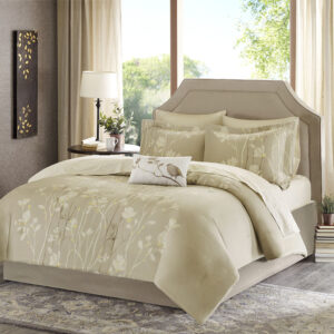 one decorative white pillow which features a beautiful bird applique in gold