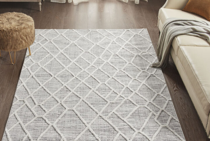 Bring a soft and contemporary update to your home with our Madison Park Ashley Terni Pebble Gray Indoor Area Rug. This area rug features a machine woven pebble geo pattern in a gray and cream palette for a fresh modern look