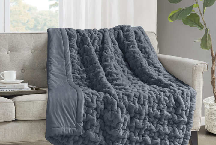 Add a modern and sophisticated touch to any space with the Madison Park Ruched Fur Throw. This throw features a solid ruched fur pattern