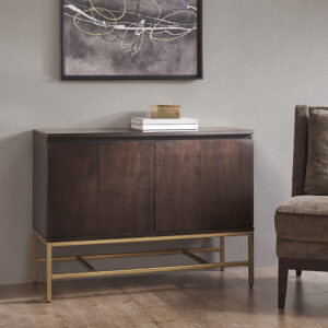 The Martha Stewart Allister Accent Cabinet offers a sleek modern storage update to your home. This accent chest features a brown wood finish on the solid wood frame with a gold metal base