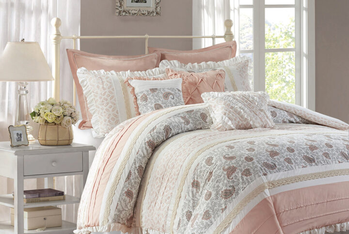 The Madison Park Dawn 9 Piece Cotton Percale Comforter Set offers a shabby chic update to your bedroom decor. A paisley print is featured on the cotton comforter with pintucked fabric separated by lace taping embellishments. Around the edge