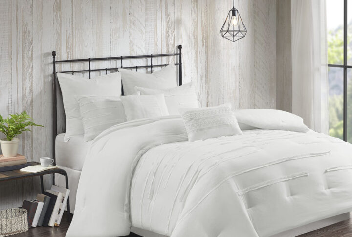 Bring a casual farmhouse look to your bedroom decor with the 510 Design Jenda 8 Piece Comforter Set. The white comforter and shams feature raw edge ribbon detailing that add dimension and texture to the top of the bed. Matching solid white Euro shams complement the casual bedding set