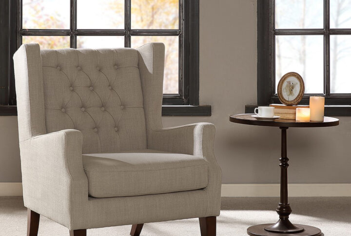 This classic wing chair with its button tufted detailing and sloped arms adds a casual twist with its linen casual woven fabric. Leg assembly required.