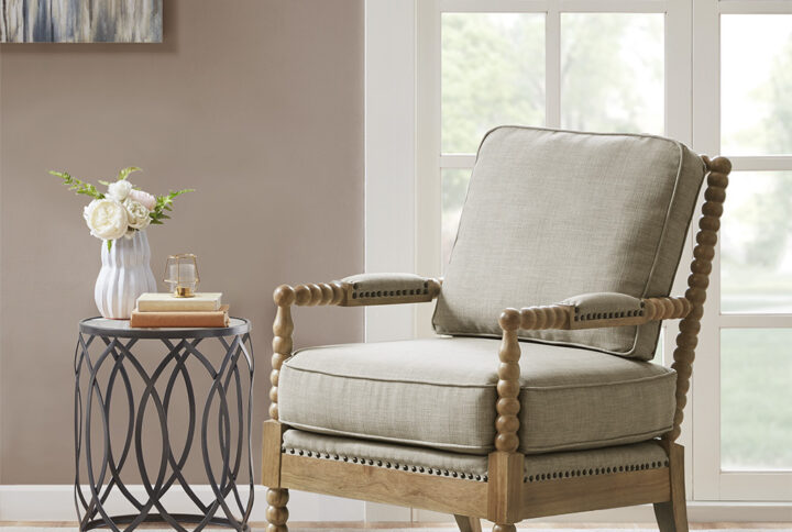 The Madison Park Donohue Accent Chair provides an elegant and comfortable update to your decor. This accent chair is upholstered in a neutral light grey fabric that creates a timeless look. A bronze nail head trim and padded arm rests add the perfect touches to the design. The solid wood legs feature a camel oak wood finish to complement the rich upholstery. Beautifully designed