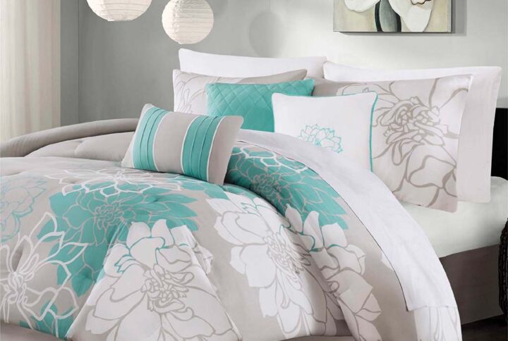 The Madison Park Lola Comforter Set transforms your bedroom into a beautiful and graceful space. A gorgeous floral print in a soft white and aqua hue pops against the solid taupe grey ground cotton sateen comforter and shams (1 for Twin/Twin XL Sizes) for a stunning transitional look. Three decorative pillows with embroidered details and fabric manipulation add texture and dimension to the bed