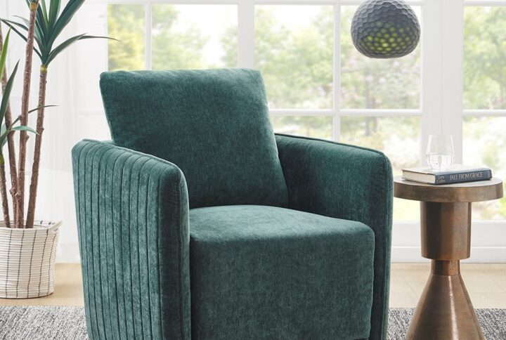 Invigorate your living room with the glamorous style of the Madison Park Kaley swivel accent chair. Upholstered in a soft green polyester blend fabric