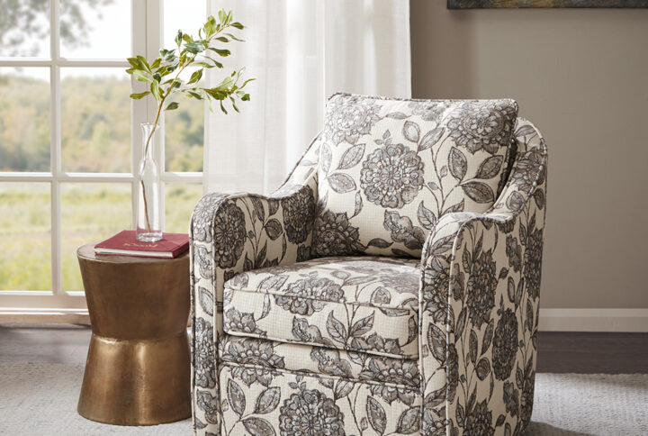 Bring simple comfort to your living room decor with the Madison Park Brianne Wide Seat Swivel Arm Chair. This swivel chair features a loose back and seat cushion that is fully upholstered for a chic transitional look. Double piping details along the frame accent the design