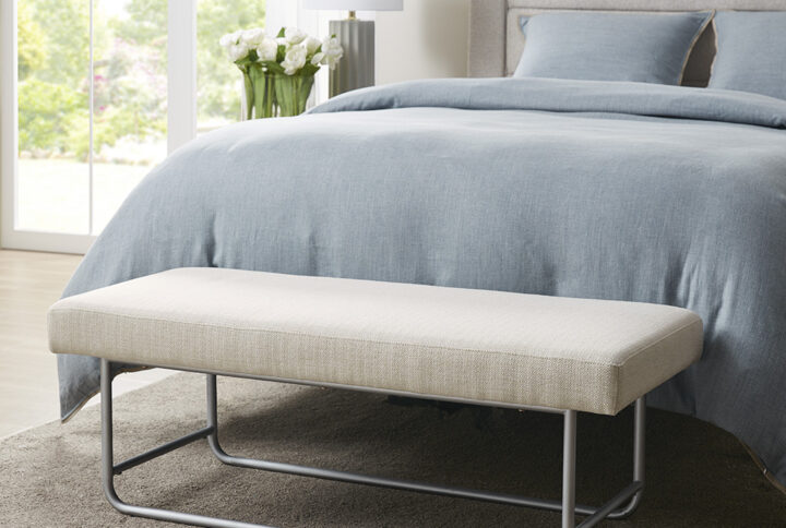 Elevate your home decor with the modern elegance of the Martha Stewart Eve Bench. This accent bench is upholstered in a rich ivory fabric and features a silver metal base to create a beautiful contemporary look. Flaunting an elegant and clean design