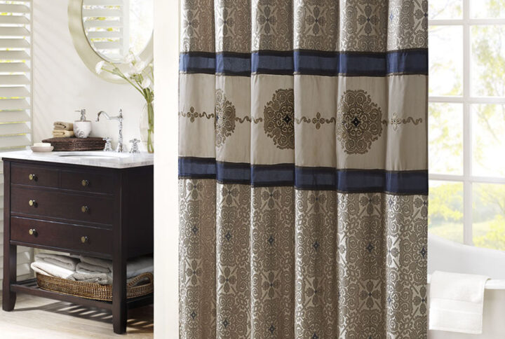 Add a touch of sophistication and elegance to your bathroom with the Donovan shower curtain. This stunning curtain features a bold color-blocked design that is accentuated with intricate embroidery details. The jacquard weave adds depth and texture to the curtain