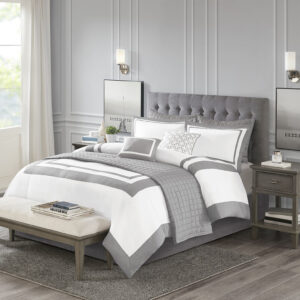 This Heritage hotel bedding collection includes a comforter and quilt that both come with matching shams to complete a luxurious layered look. The soft comforter and shams showcase a bold border on a white ground with a solid white reverse