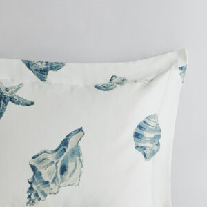 casual Beach House bedding collection from Harbor House. The duvet cover features a shell pattern that is printed in shades of blue onto a white