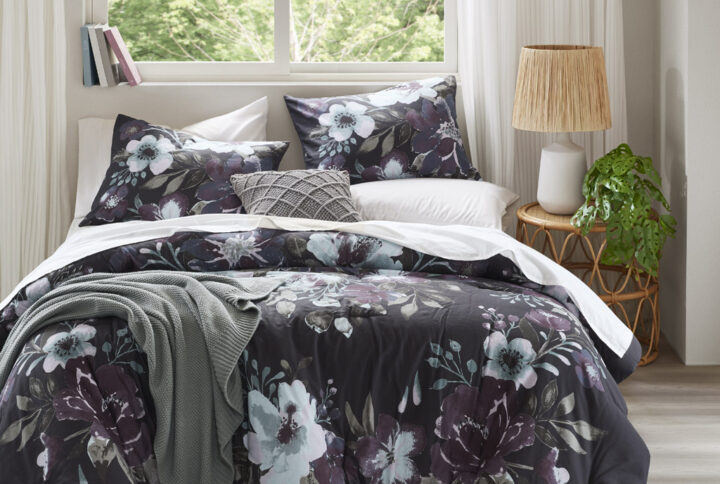 Transform your bedroom into a serene retreat with the Madison Park Jolene 3 Piece Cotton Floral Printed Comforter Set. This King/Cal King comforter set features a dark grey and plum floral pattern on a 100% cotton face