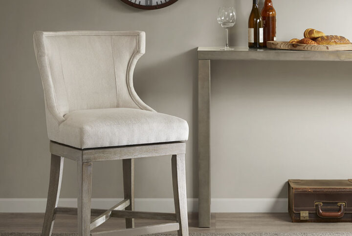 Define your dining area with the elegance of the Madison Park Carson Counter Stool with Swivel Seat. This pholstered wingback style counter chair features clean lines and curve