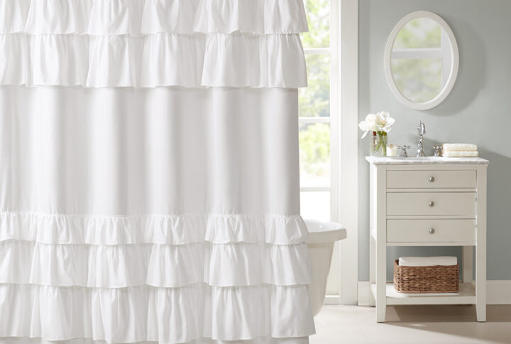 The Madison Park Grace shower curtain provides the perfect shabby chic update in your space. The solid light white fabric features overscale ruffles at the top and bottom of the curtain