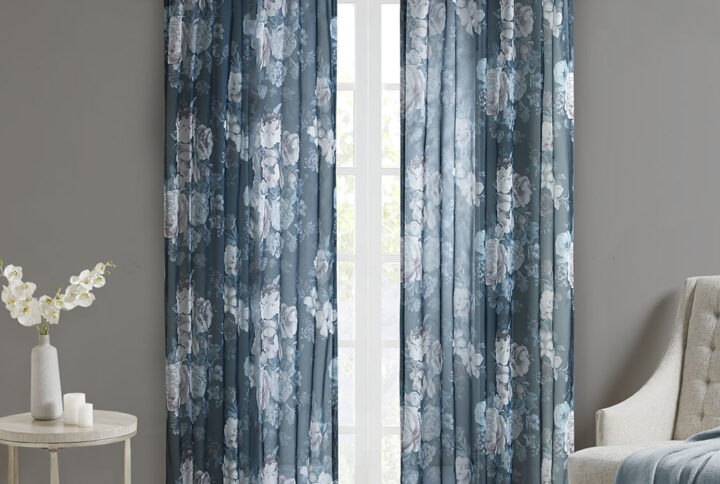 The Madison Park Simone Printed Floral Rod Pocket and Back Tab Top Voile Sheer brings a soft and romantic touch to your home decor. This voile sheer curtain panel features a beautiful blush and neutral printed floral on a dark navy ground for a rich and stylish contrast