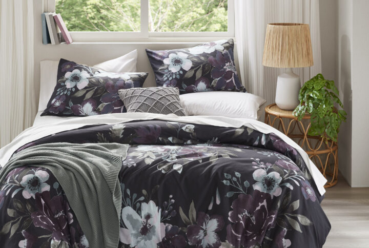 Transform your bedroom into a serene retreat with the Madison Park Jolene 3 Piece Cotton Floral Printed Duvet Cover Set. This King/Cal King duvet cover set features a dark grey and plum floral pattern on a 100% cotton face