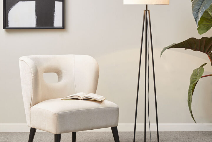 The Martha Stewart Clyde Metal Tripod Floor Lamp 60"H offers a simple and modern update to elevate your living room decor. This floor lamp features a metal tripod base in a matte black finish that creates a slender and sleek contemporary look. The drum shade is not adjustable and is made from white linen to softly filter light and provide a chic contrast to the base of this floor lamp. This tripod floor lamp also uses a foot switch and gives your home a sharp modern accent. 1 Type A light bulb is needed(not included). Spot clean only. Comes with a 2-year warranty.