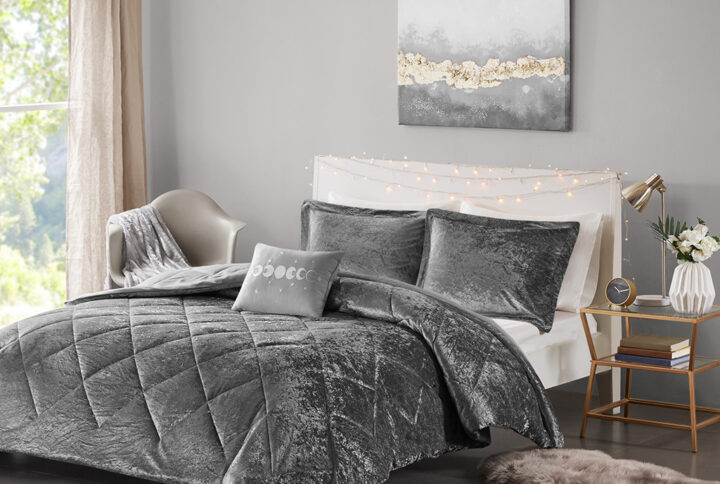 Create a lush and relaxing atmosphere in your bedroom with the Intelligent Design Felicia Velvet Comforter Set. The grey comforter is made from crushed velvet and features diamond quilting for a luxurious look. Matching crushed velvet sham(s) and an oblong decorative pillow complement the comforter to complete the modern style bedding set. Machine washable for easy care