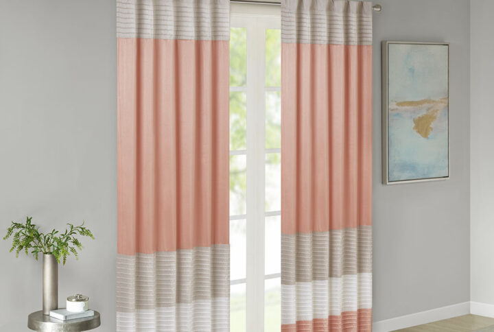 Amherst's modern color block design is a simple way to add style to your room. This window panel features color block stripes in warm hues of coral and taupe combined with pintuck detailing for beautiful texture and dimension. Added lining helps to filter the perfect amount of light and creates a fuller look. Hang using the rod pocket or back tabs for a tailored look. Fits up to 1.25" diameter rod.