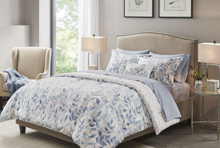 The Madison Park Essentials Sofia Reversible Comforter Set with Sheet Set offers a beautiful update for your entire bed. A botanical print