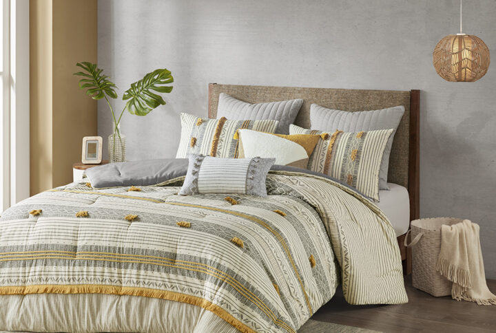 The INK+IVY Cody 3 Piece Cotton Comforter Set brings a smart combination of texture and style to your bedroom. This 100% cotton comforter features a grey and yellow striped print with pompom and trim details for a casual