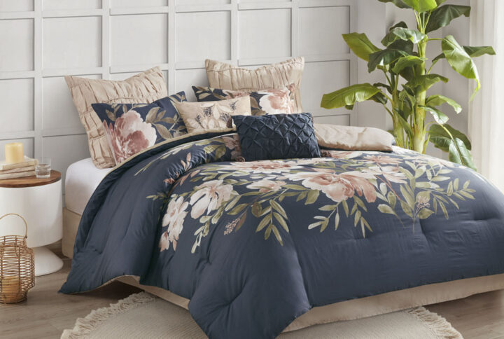 Bring beauty and graceful style to your bedroom with the Madison Park Camillia 8 Piece Cotton Comforter Set. The navy comforter and 2 matching shams feature a large blush floral print to create a stunning shabby chic look. A solid blush reverse adds a soft touch of color to contrast the face of the comforter. The 2 blush Euro shams flaunt a ruffled texture that adds dimension to the bed