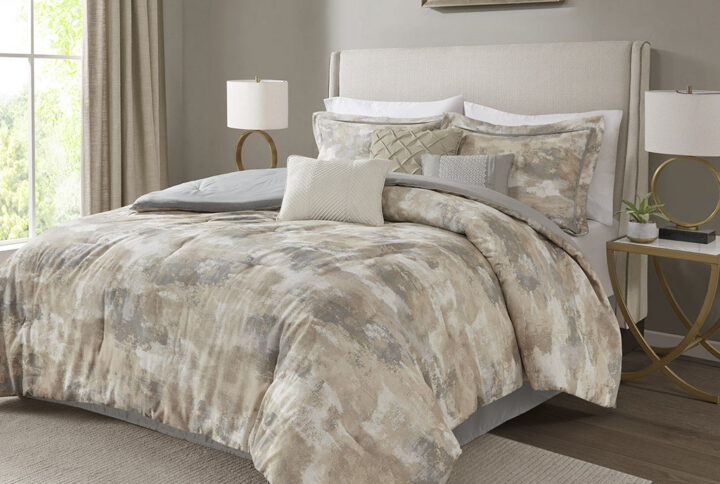 Modernize your bedroom decor with the chic styling of the Madison Park Beacon 7 Piece Comforter Set. This luxurious comforter features an abstract print in various gray