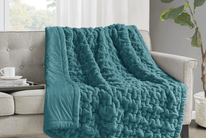 Add a modern and sophisticated touch to any space with the Madison Park Ruched Fur Throw. This throw features a solid ruched fur pattern