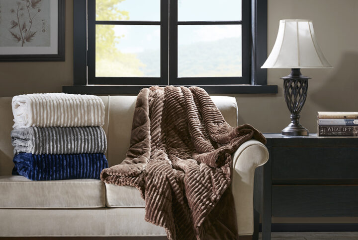 Keep yourself warm and cozy with this oversized Parker plush down alternative throw. This throw features an ultra-soft ribbed plush face with a solid plush reverse