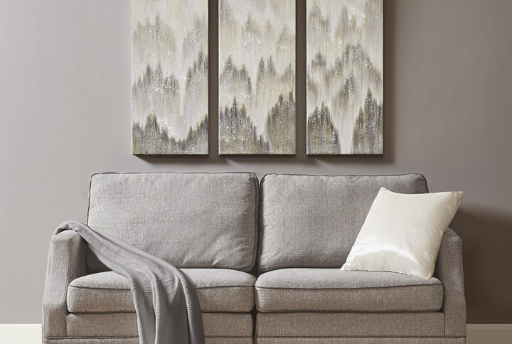 Give your décor a glamorous modern touch with the Madison Park Sterling Mist hand embellished canvas 3 piece set. This canvas wall art set features an abstract design in shades of grey with glitter embellishments spans across each of the three canvases for a contemporary look. 100% hand embellished accents add dimension and texture to the design