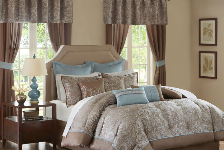 The Madison Park Essentials Brystol 24 Piece Room in a Bag provides a total makeover for your bedroom decor. This traditional comforter flaunts a soft blue and taupe jacquard paisley pattern with an accenting solid brown border to create a luxurious glam look. Matching pillow shams and solid soft blue Euro shams with 2-inch flanges coordinate beautifully with the elegant comforter. A solid brown bed skirt and 4 decorative pillows with embroidery and pleating details add the finishing touches to this paisley bedding set. Hypoallergenic polyester filling in the comforter and pillows contains no allergens and is treated to be dustproof. A 4 Piece sheet set is also included to complement the comforter and complete the jacquard bedding set. To elevate your bedroom